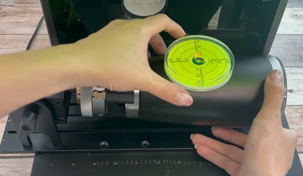 Checking if the Yeti cup is level on the rotary attachment before engraving