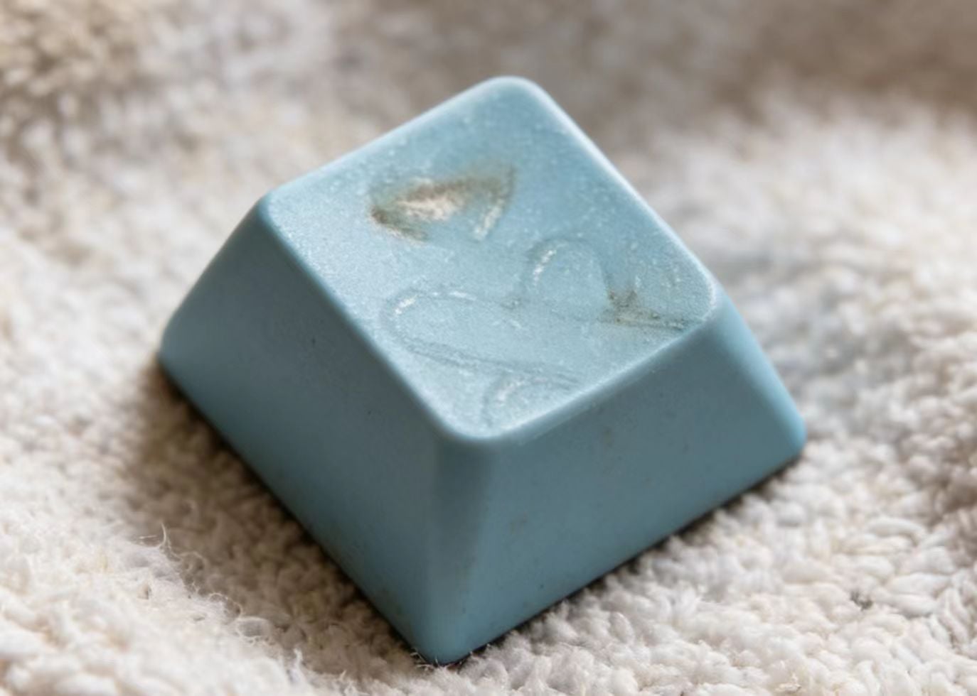 Damaged ABS keycap from diode laser engraving